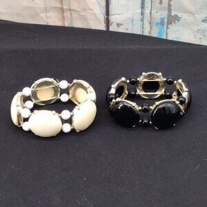 Taramanda Two Black Cream Beads Set in a Gold Tone Metal on Stretch Band Style B